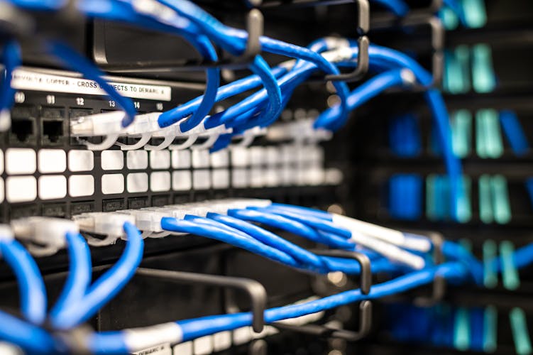 Blue ethernet cables connected to server infrastructure representing system integration
